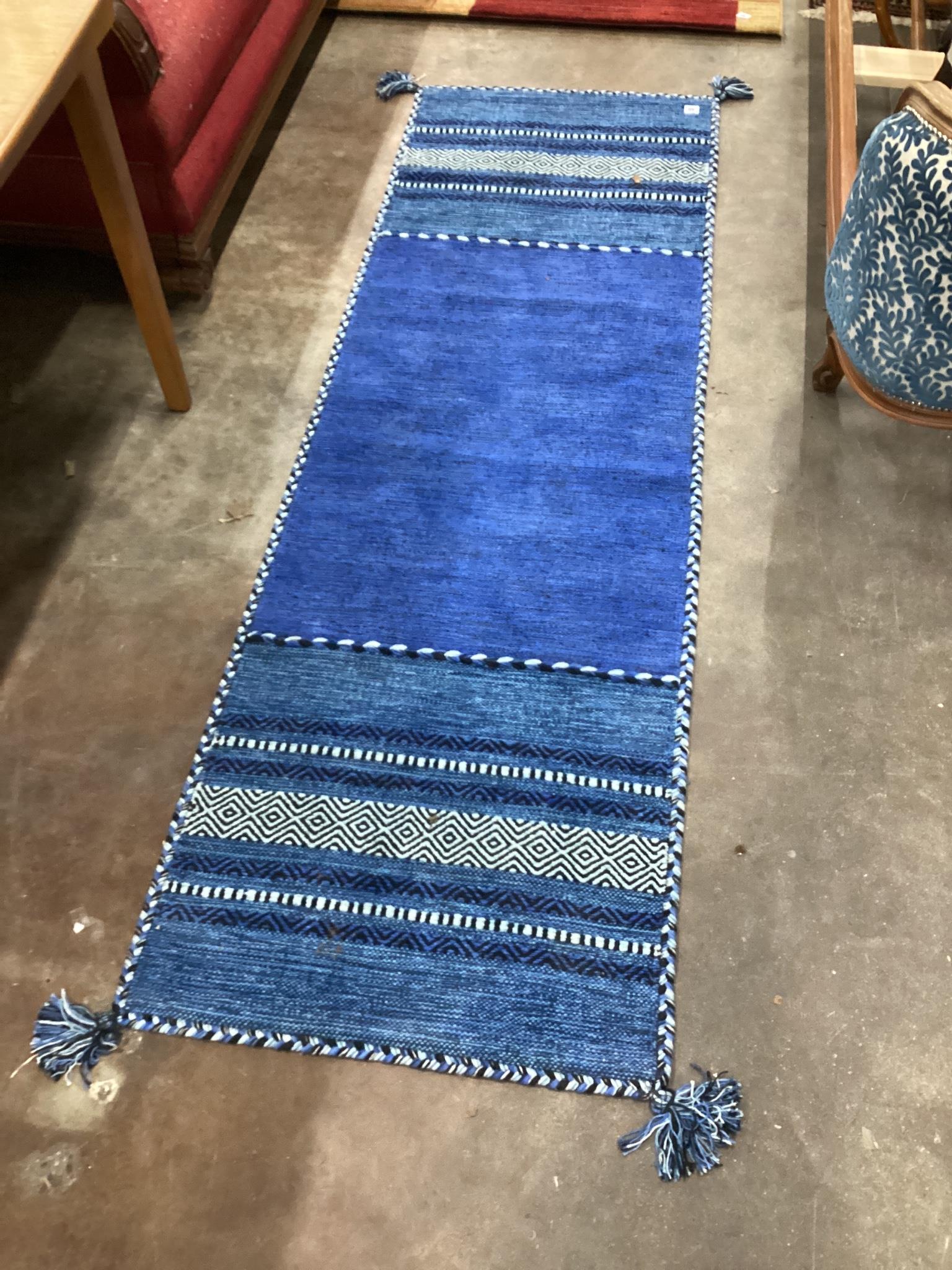 A contemporary flat weave runner 220cm x 70cm